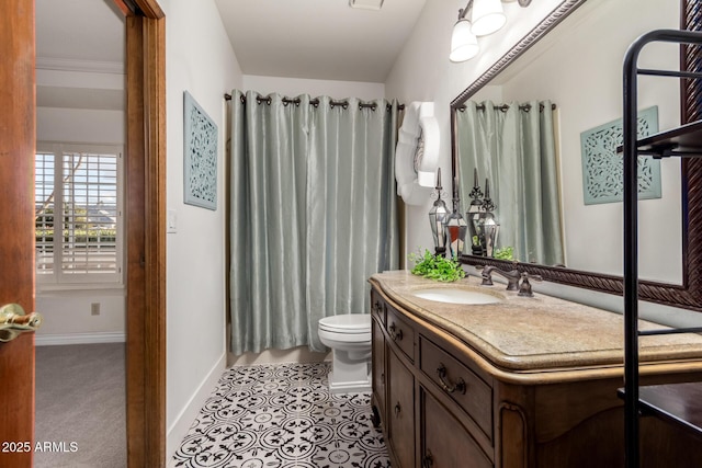 bathroom featuring vanity, tile patterned floors, and toilet