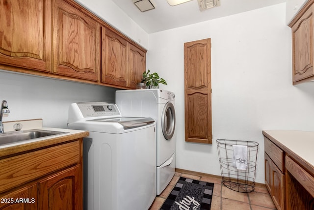 clothes washing area featuring cabinets, independent washer and dryer, and sink