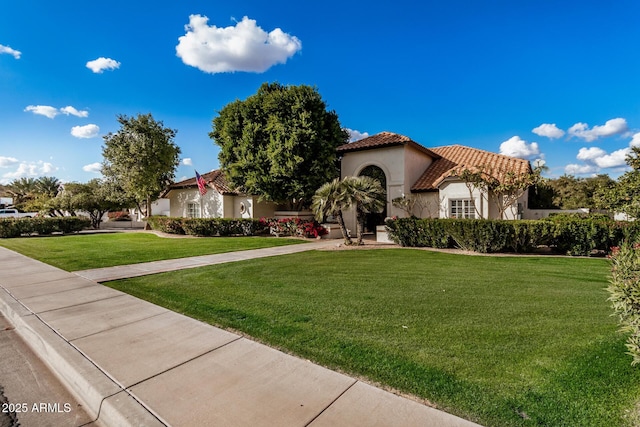 mediterranean / spanish-style house featuring a front yard