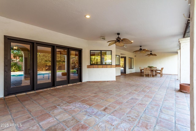 view of patio featuring ceiling fan and french doors