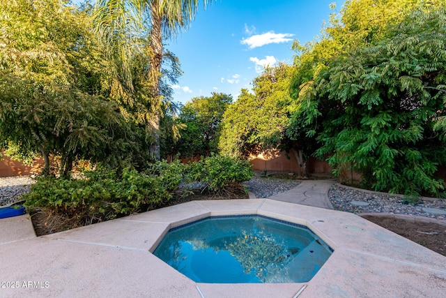 view of swimming pool featuring a jacuzzi