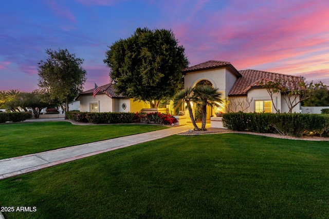 mediterranean / spanish house with a lawn