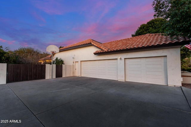 property exterior at dusk with a garage