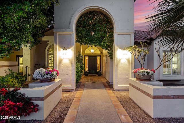 view of exterior entry at dusk