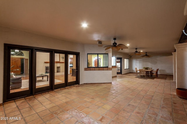 interior space with ceiling fan and french doors