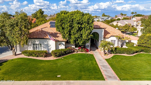 mediterranean / spanish home with a front yard