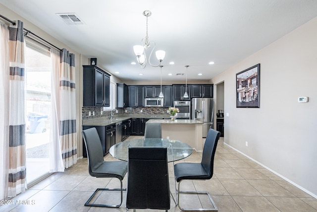 tiled dining area with an inviting chandelier and sink