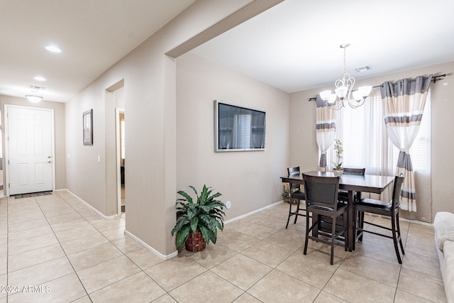 tiled dining area featuring an inviting chandelier