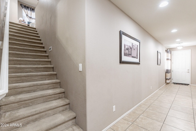 staircase featuring tile patterned flooring