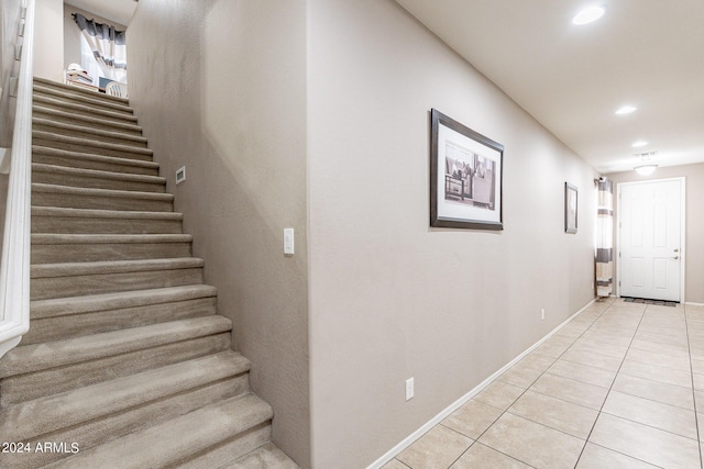 staircase with tile patterned floors, recessed lighting, and baseboards