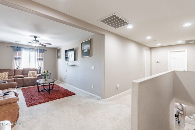 carpeted living room featuring ceiling fan