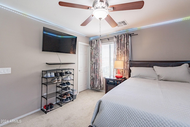 bedroom with carpet flooring, baseboards, visible vents, and a ceiling fan