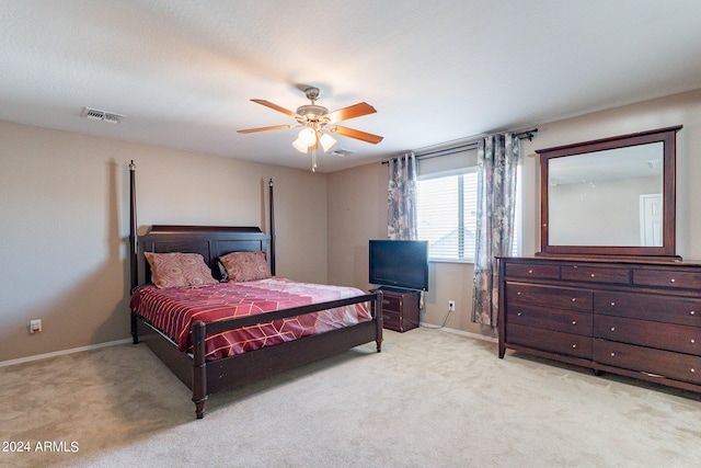 bedroom with light colored carpet, visible vents, and baseboards