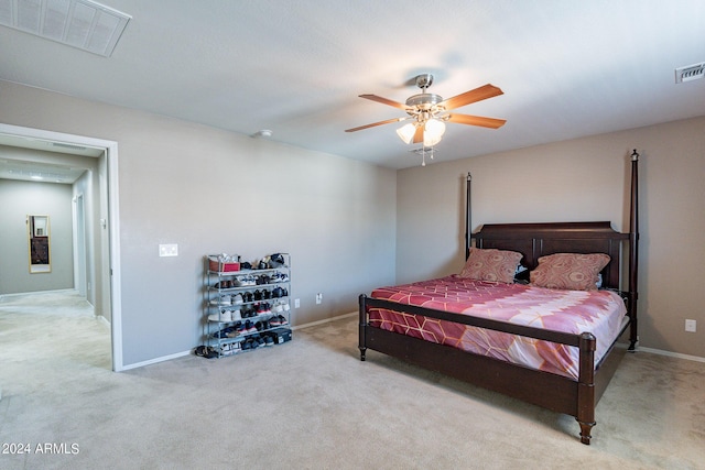 bedroom featuring baseboards, visible vents, a ceiling fan, and carpet