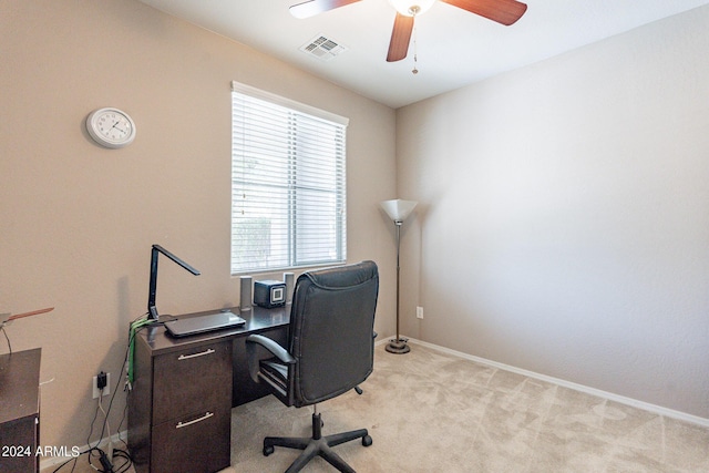 home office with visible vents, baseboards, light colored carpet, and a ceiling fan