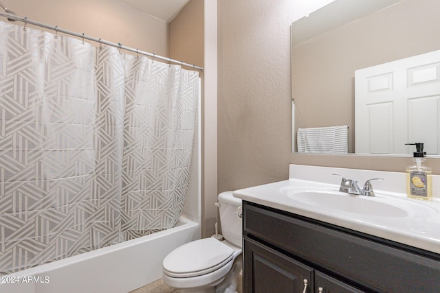 bathroom featuring shower / bath combo with shower curtain, toilet, vanity, and a textured wall