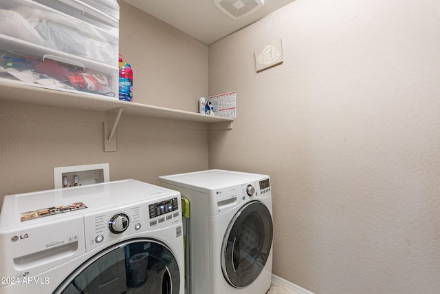 clothes washing area with washer and dryer