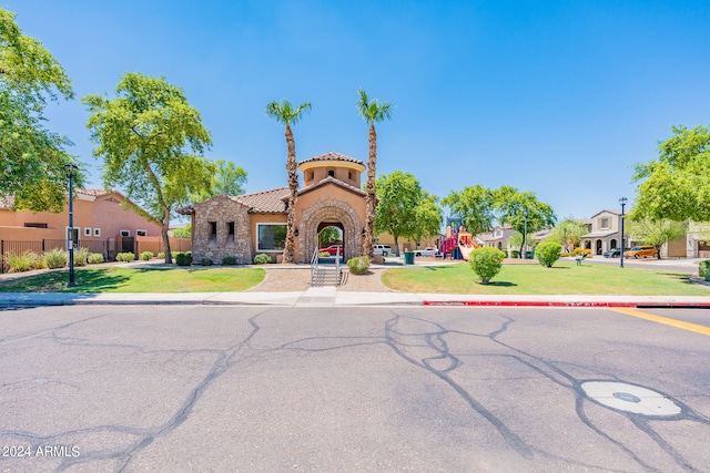 view of front of home featuring a playground and a front lawn