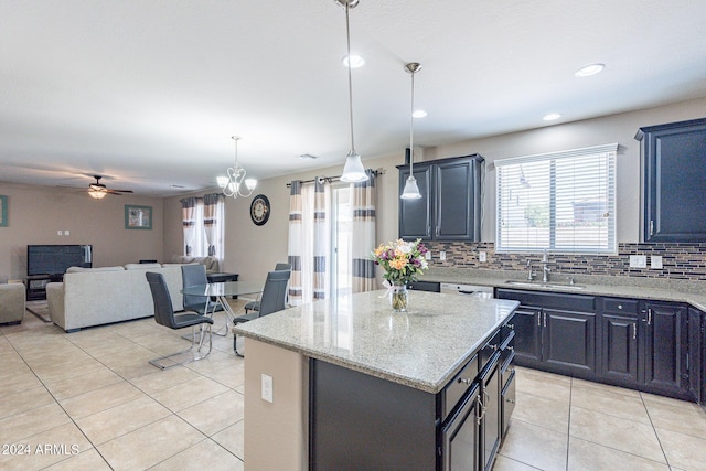 kitchen with decorative backsplash, light tile patterned floors, a kitchen island, and a sink