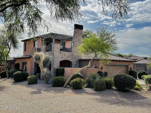 7751 E Golden Eagle Cir, Gold Canyon, AZ 85118 - view of front of property with a garage, a balcony, a chimney, stone siding, and stucco siding