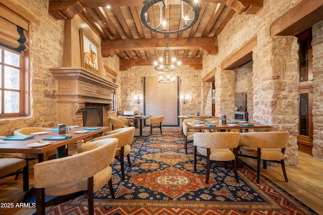 7751 E Golden Eagle Cir, Gold Canyon, AZ 85118 - living area with a chandelier, wood finished floors, a fireplace, wood ceiling with exposed beams, and a towering ceiling