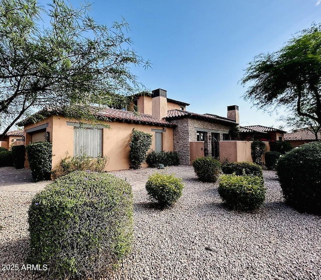 7751 E Golden Eagle Cir, Gold Canyon, AZ 85118 - view of front of property with a chimney, stucco siding, an attached garage, a tiled roof, and stone siding