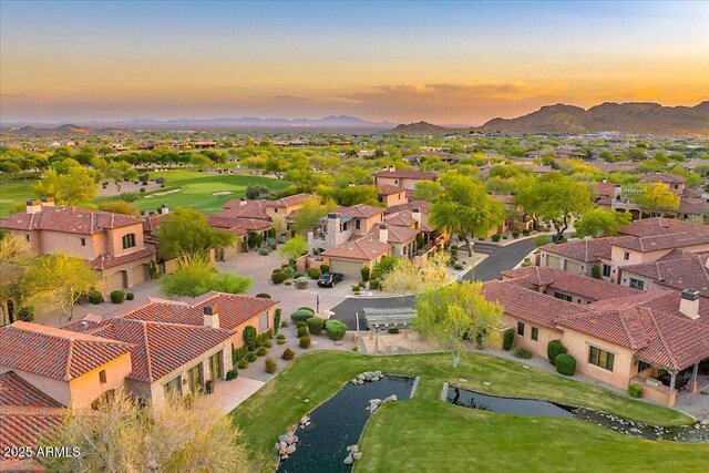 7751 E Golden Eagle Cir, Gold Canyon, AZ 85118 - aerial view at dusk of a residential view, view of golf course, and a water and mountain view