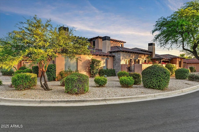 7751 E Golden Eagle Cir, Gold Canyon, AZ 85118 - mediterranean / spanish-style house with stucco siding, a chimney, and a tiled roof