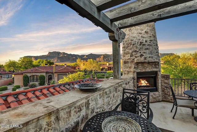 7751 E Golden Eagle Cir, Gold Canyon, AZ 85118 - view of patio featuring an outdoor stone fireplace and a mountain view