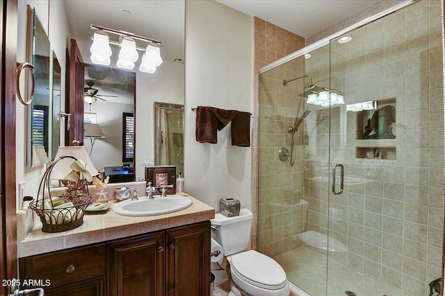 7751 E Golden Eagle Cir, Gold Canyon, AZ 85118 - bathroom featuring vanity, a stall shower, toilet, and ceiling fan
