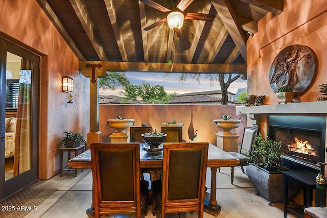 7751 E Golden Eagle Cir, Gold Canyon, AZ 85118 - view of patio featuring a warm lit fireplace, outdoor dining area, and a ceiling fan
