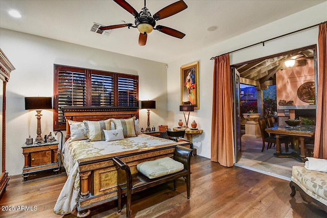 7751 E Golden Eagle Cir, Gold Canyon, AZ 85118 - bedroom with wood finished floors, access to exterior, and a ceiling fan