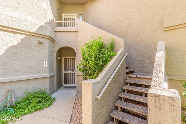 property entrance with stucco siding