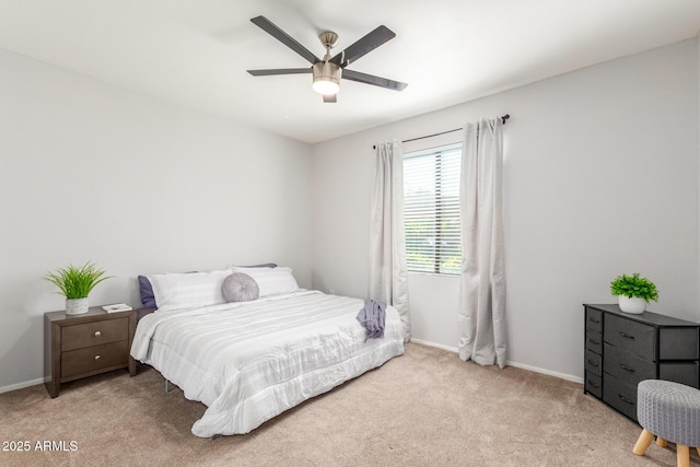 carpeted bedroom with a ceiling fan and baseboards