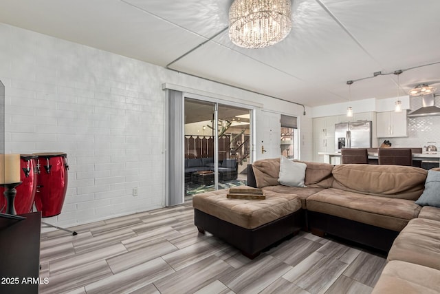 living room featuring light hardwood / wood-style floors and a notable chandelier