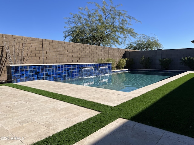 view of swimming pool featuring pool water feature and a patio area