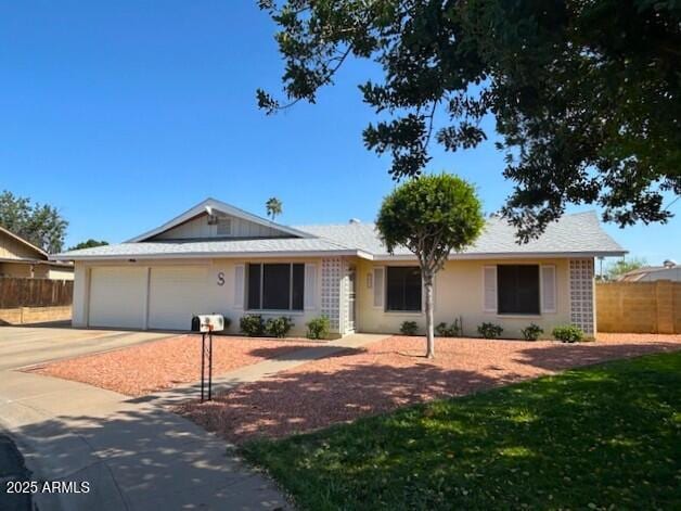 3242 W Christy Dr, Phoenix, AZ 85029 - ranch-style house with concrete driveway, fence, and an attached garage