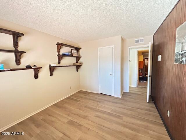 3242 W Christy Dr, Phoenix, AZ 85029 - unfurnished bedroom featuring visible vents, a textured ceiling, and light wood-type flooring