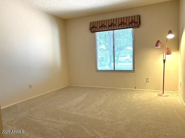 3242 W Christy Dr, Phoenix, AZ 85029 - spare room featuring carpet flooring and a textured ceiling