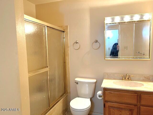 3242 W Christy Dr, Phoenix, AZ 85029 - full bathroom featuring toilet, bath / shower combo with glass door, and vanity