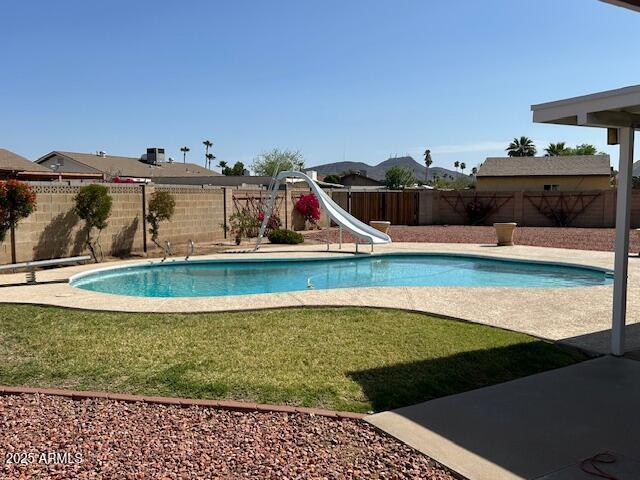 3242 W Christy Dr, Phoenix, AZ 85029 - view of swimming pool featuring a fenced backyard, a lawn, a water slide, and a fenced in pool