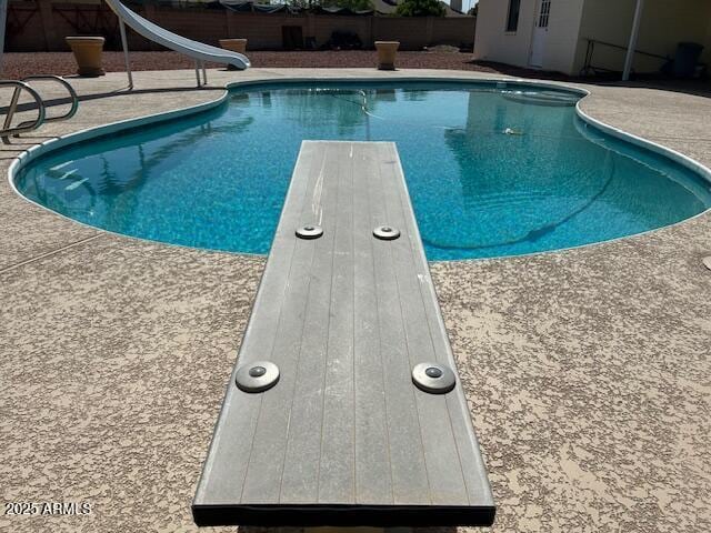 3242 W Christy Dr, Phoenix, AZ 85029 - view of swimming pool with fence, a diving board, a water slide, a fenced in pool, and a patio area