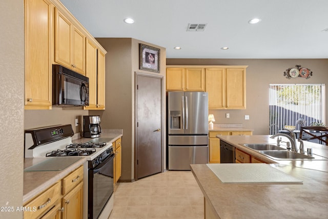 kitchen with black appliances, sink, and light brown cabinets