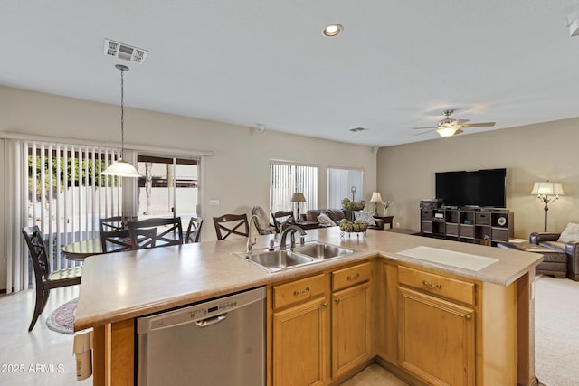 kitchen featuring sink, stainless steel dishwasher, a healthy amount of sunlight, and a kitchen island