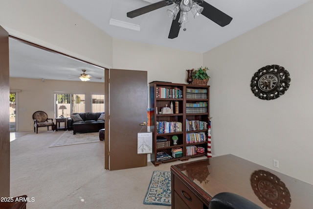 carpeted home office featuring ceiling fan