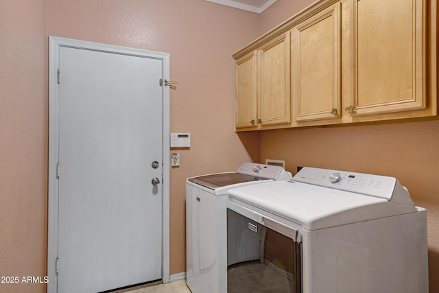 laundry room featuring cabinets and washing machine and clothes dryer