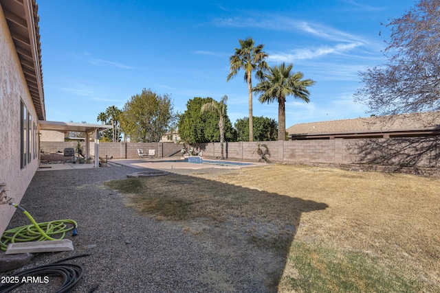 view of yard with a fenced in pool and a patio