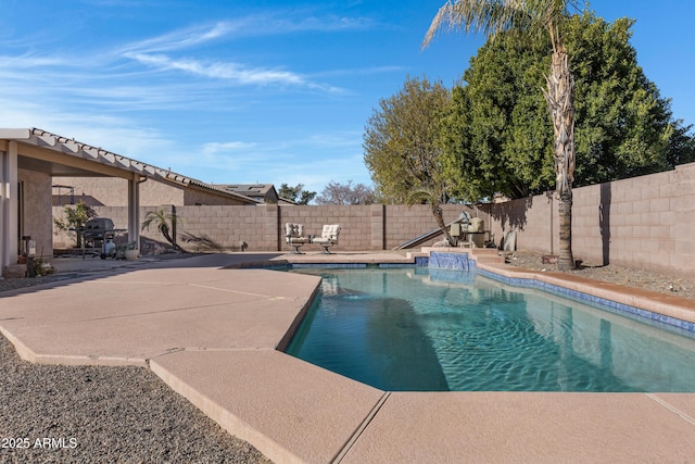 view of pool featuring pool water feature and a patio