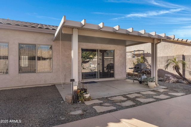 view of exterior entry with a patio