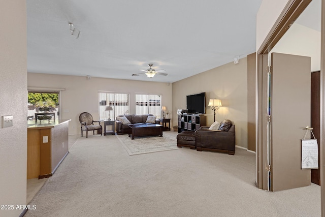 carpeted living room featuring ceiling fan and a wealth of natural light